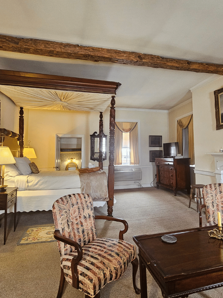 Historically decorated Jubal Early Suite at The Historic Wayside Inn 1797, featuring a classic double bed and antique period furnishings in Middletown, VA.