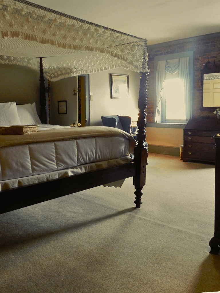 The Reeves State Room at The Historic Wayside Inn 1797, featuring a King bed and elegant antique decor in Middletown, VA.