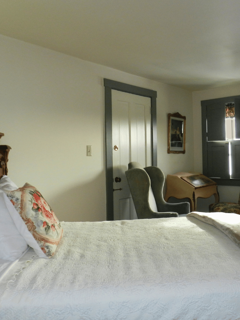 The Taylor Room (Room 8) at The Historic Wayside Inn 1797, featuring a classic double bed and adjoining access to the Jefferson Room in Middletown, VA