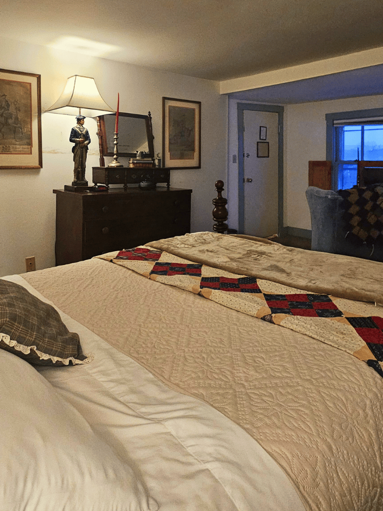 Queen bed and antique furnishings in the Tyler Room (Room 11) at The Historic Wayside Inn 1797, Middletown, VA