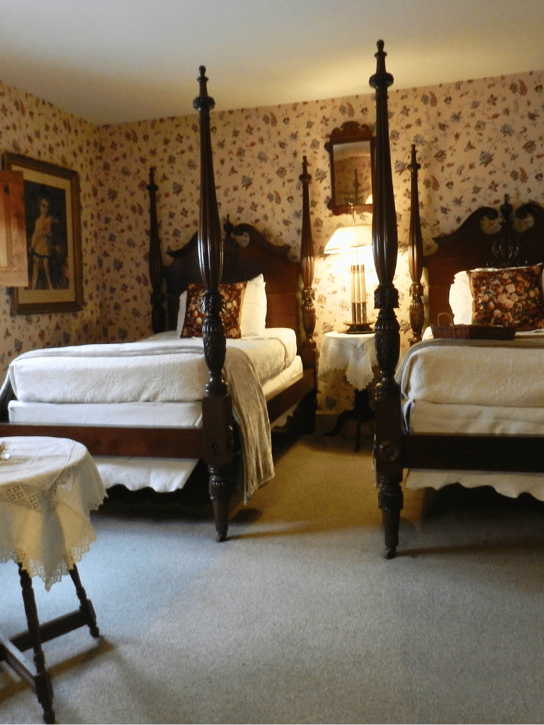 The Wilkenson Room at The Historic Wayside Inn 1797, featuring two twin beds and antique furnishings in Middletown, VA.